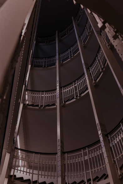 Looking up at a half-winding staircase with white banisters and dark ballustrade.