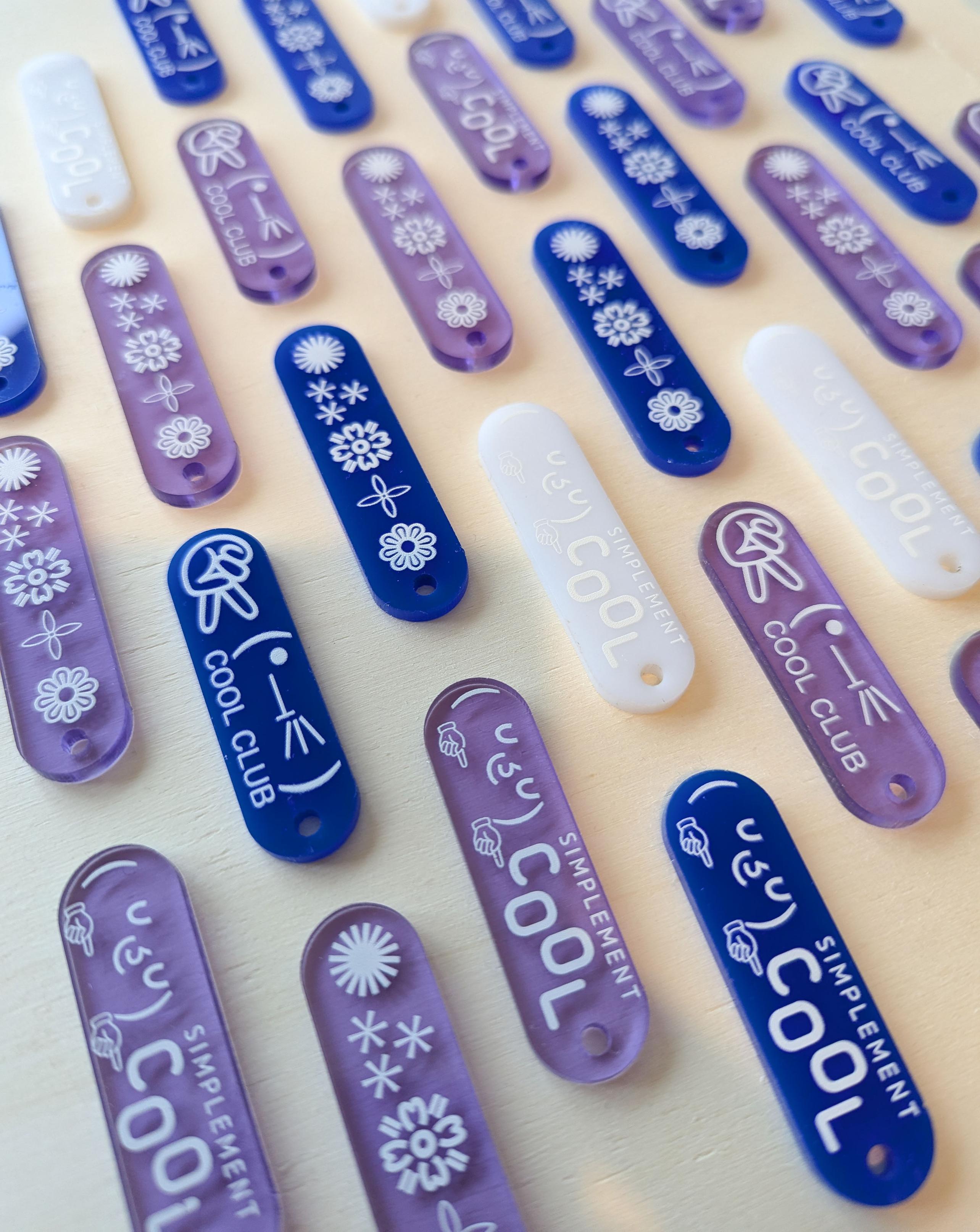 multiple blue, violet and white keychains