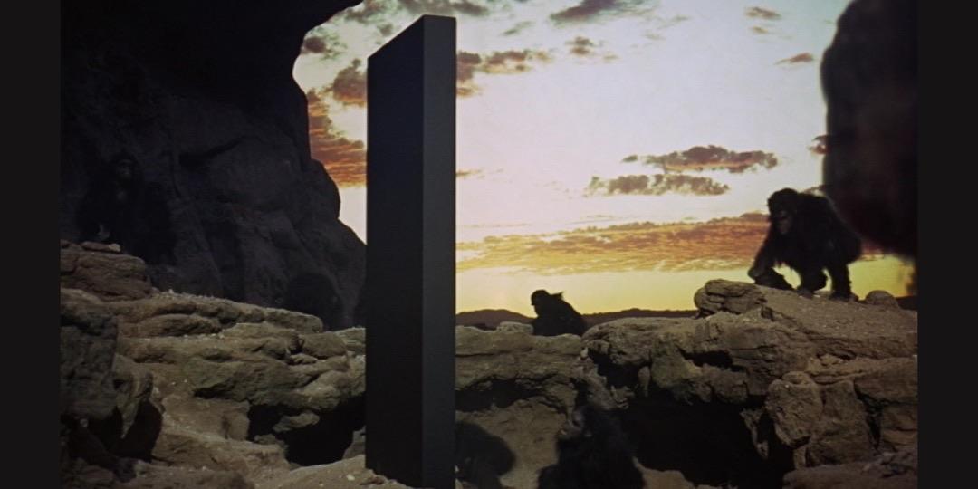 Frame from 2001: A Space Odyssey featuring the monolith and apes 