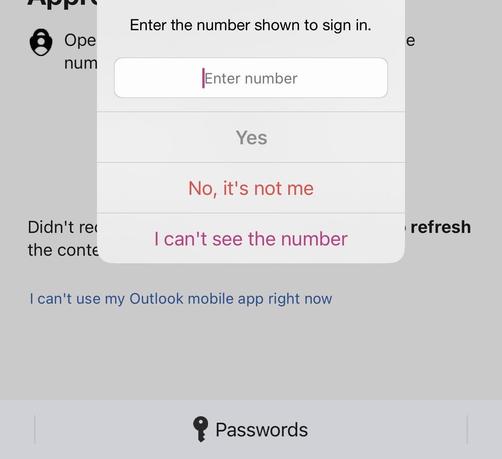 A cropped screenshot of Outlook on iOS 26 displaying a login prompt with a two digit number covered by a modal that reads: Enter the number shown to sign in. Yes No, it’s not me I can’t see the number