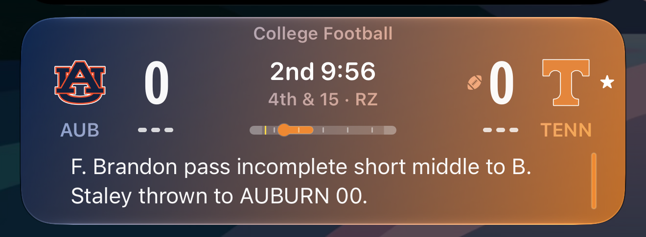 A cropped screenshot of a live activity displaying on the iOS 27 lock screen, Apple Sports showing the Aub vs Tenn college football game.